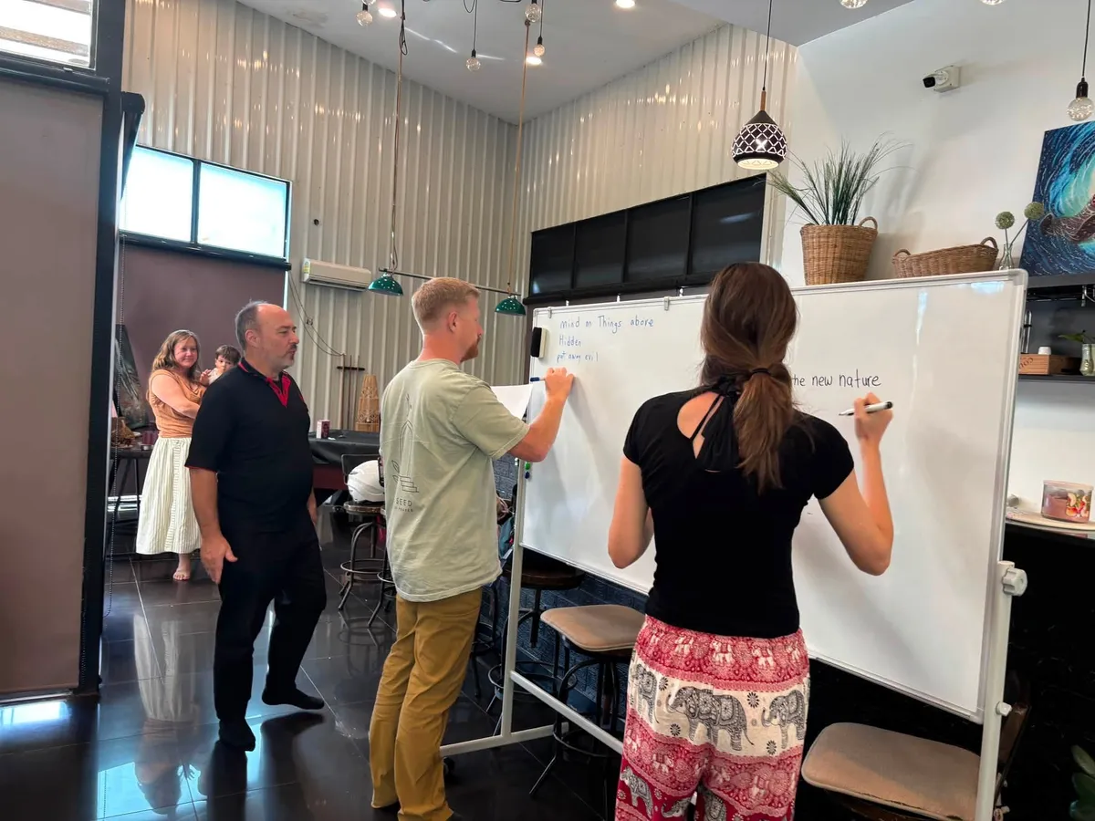 Wellspring students writing on the whiteboard during a session